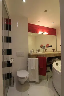 a bathroom with a white toilet and a sink at Stay Nexus Galaxy Center in Sofia