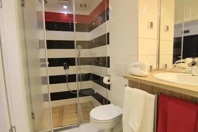 a bathroom with a shower and a toilet and a sink at Stay Nexus Galaxy Center in Sofia
