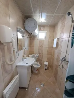 a bathroom with a sink and a toilet and a shower at Къща за гости Съкровище in Panagyurishte