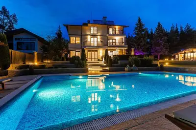a swimming pool in front of a house at night at Villa 1331 in Zheleznitsa