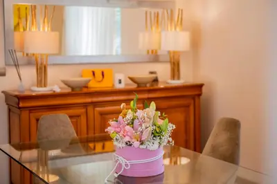 a glass table with a vase of flowers on it at Villa 1331 in Zheleznitsa