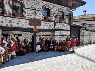 a group of people posing in front of a building at Todeva House Hotel and Tavern in Bansko