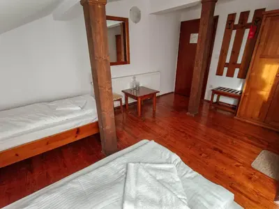 a bedroom with two bunk beds and a wooden floor at Todeva House Hotel and Tavern in Bansko