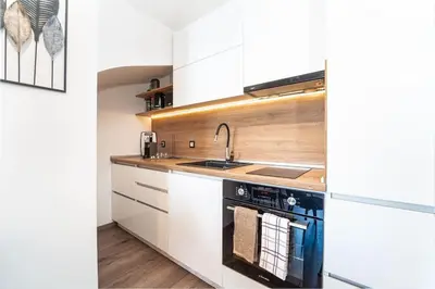a kitchen with a sink and a stove at Alpin Penthouse 2 Bedroom with Fireplace and Mountain View in Bansko