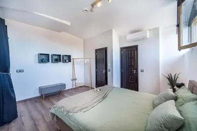 a bedroom with a large bed in a room at Alpin Penthouse 2 Bedroom with Fireplace and Mountain View in Bansko
