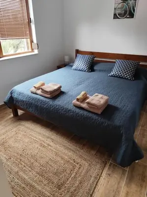 a bedroom with a bed with two towels on it at Only You Boutique Apartment in Sofia