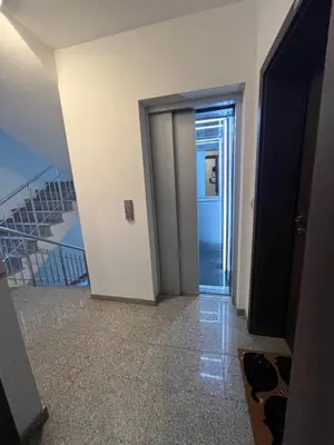 a hallway with a door and stairs in a building at Уютен тристаен апаратамент,намиращ се на тиха и спокойна улица in Sofia