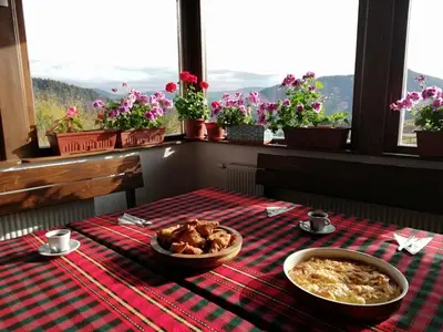 a table with a plate of food and a bowl of food at Guest House Panorama in Gela