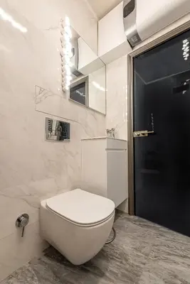 a bathroom with a white toilet and a black door at Vespa Home Boutique Apartment in Sofia