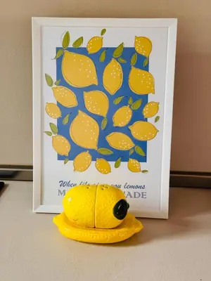 a yellow fish toy sitting in front of a picture at Vespa Home Boutique Apartment in Sofia