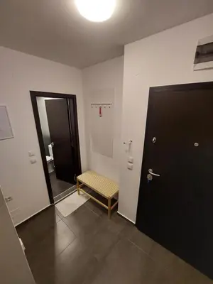 a bathroom with a black door and a stool next to a mirror at Sky Hills 2 Apartment in Sandanski