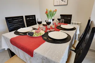 a table with plates of food and glasses of wine at SouthPark Luxe - Free Underground Parking - Metro in Sofia