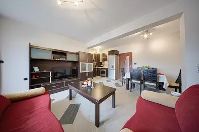 a living room with a red couch and a table at SouthPark Luxe - Free Underground Parking - Metro in Sofia