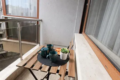 a table with a plate of food on a balcony at SouthPark Luxe - Free Underground Parking - Metro in Sofia
