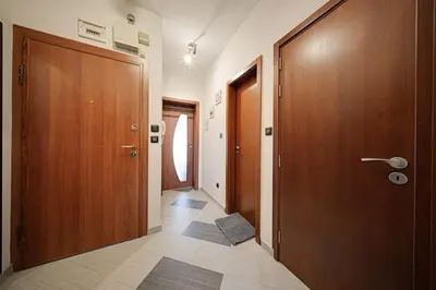 a hallway with two wooden doors and a tile floor at SouthPark Luxe - Free Underground Parking - Metro in Sofia