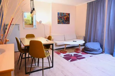 a living room with a table and a couch at National Theatre Loft in Sofia