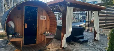 a wooden sauna with a round door and a mirror at Apartment in Aspen Golf in Bansko