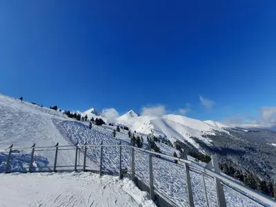 a snow covered mountain with a fence on it at Apartment in Aspen Golf in Bansko