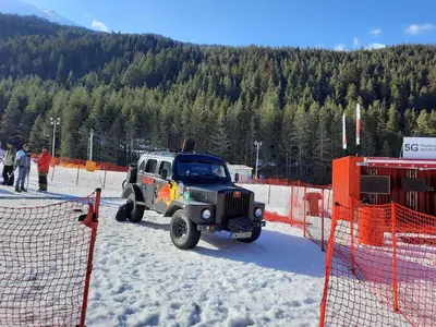 a jeep parked in the snow next to an orange fence at Apartment in Aspen Golf in Bansko