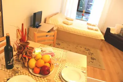 a dining room table with a bowl of fruit on it at Apartment in Aspen Golf in Bansko