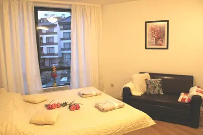 a bedroom with a bed with flowers on it at Apartment in Aspen Golf in Bansko