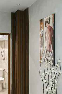 a room with a painting of a woman on the wall at Velar 1BDR Apartment in Sofia