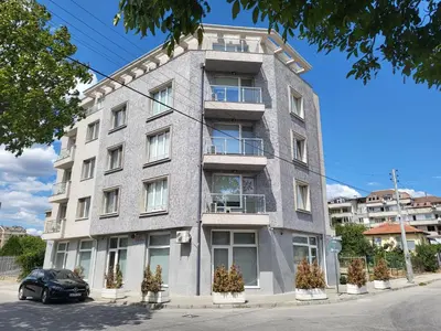 a building with a car parked in front of it at Апартамент Димана in Hisarya