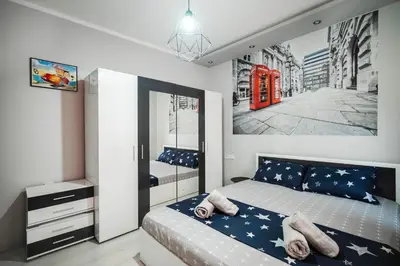 a bedroom with a bed and a red phone booth at Feel Right at Home - Bright and Modern Apartment by Flat Mаnager in Sofia