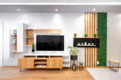 a living room with a flat screen tv on a wall at Feel Right at Home - Bright and Modern Apartment by Flat Mаnager in Sofia
