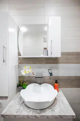 a bathroom with a white sink on a marble counter at Feel Right at Home - Bright and Modern Apartment by Flat Mаnager in Sofia