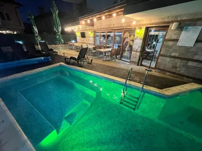a swimming pool with green lighting in a building at Mineral 56 in Banya