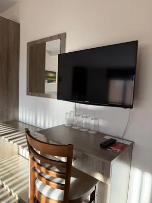 a room with a table with a television on a wall at Mineral 56 in Banya