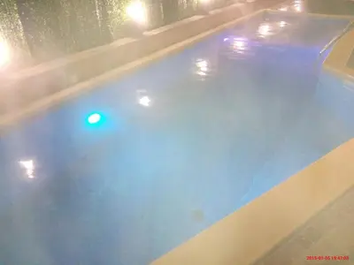 a large swimming pool with a green light in it at Mineral 56 in Banya