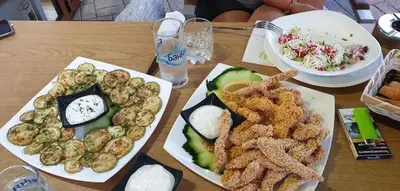 a wooden table with two plates of food on it at Mineral 56 in Banya