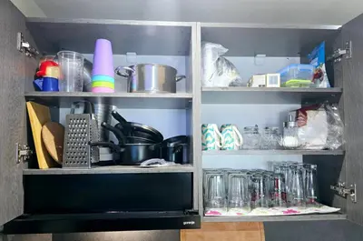 a cupboard filled with lots of kitchen items at Apartment with veranda in Bansko