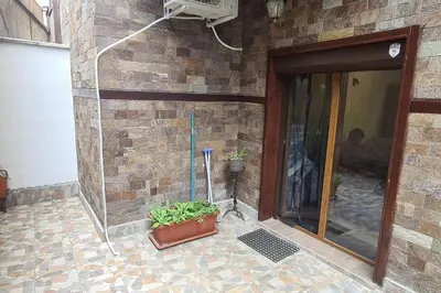 a stone building with a glass door and a plant at Apartment with veranda in Bansko