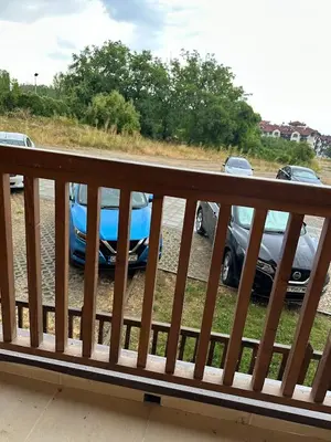 a couple of cars parked in a parking lot at Simple and Affordable Apartment in Bansko with available parking space in Bansko