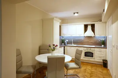 a small kitchen with a white table and chairs at Central Apartment 2 in Sofia