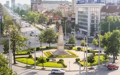 a monument in the middle of a city with cars at Central Apartment 2 in Sofia