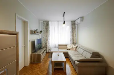 a living room with a couch and a table at Central Apartment 2 in Sofia