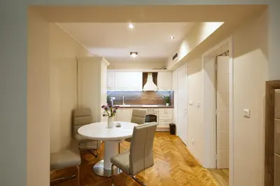 a small kitchen with a white table and chairs at Central Apartment 2 in Sofia