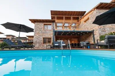 a villa with a swimming pool and a house at Aqua Thermal Villa Banya in Banya
