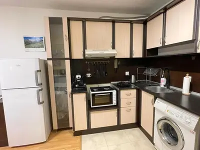 a kitchen with a white refrigerator and a dishwasher at Blue Orchid Studio near airport & free parking in Sofia