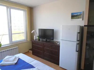 a kitchen with a white refrigerator and a tv at Blue Orchid Studio near airport & free parking in Sofia