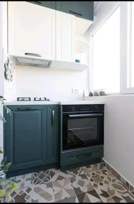 a kitchen with a black oven in a room at Домът на Билкарката in Plovdiv