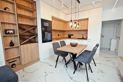 a kitchen with a wooden table and chairs at AGIA- luxury apartment Sofia in Sofia