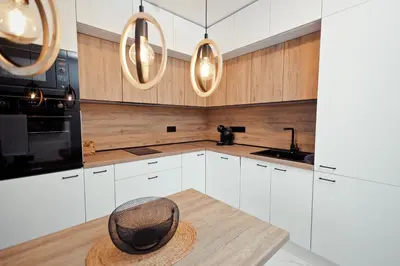 a kitchen with white cabinets and a hat on a table at AGIA- luxury apartment Sofia in Sofia