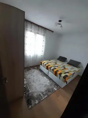 a small bedroom with a bed and a window at Levkov in Petrich