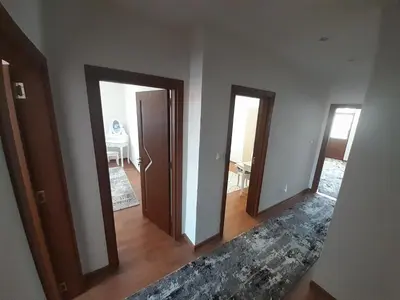 a hallway with three doors in a room with a table at Levkov in Petrich