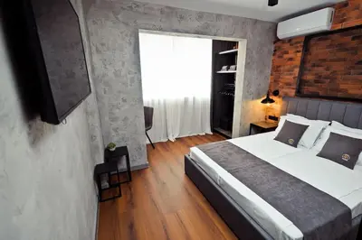 a bedroom with a large bed and a window at AGIA 2 - cozy one room apartment in Sofia